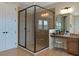 Bathroom featuring a glass enclosed shower, vanity, granite counters, and a make-up station with seat at 7315 Bianco Duck Ct, Sarasota, FL 34240