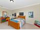 Bright bedroom with neutral walls, carpeted floor, wooden bed and dressers and decorated with playful posters at 7315 Bianco Duck Ct, Sarasota, FL 34240