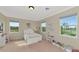 Bright bedroom with neutral walls, carpeted floor, and white furniture set. Natural light fills the space at 7315 Bianco Duck Ct, Sarasota, FL 34240