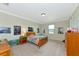Bright bedroom with neutral walls, carpeted floor, wooden bed and dressers and decorated with playful posters at 7315 Bianco Duck Ct, Sarasota, FL 34240