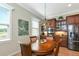 Cozy dining area with wooden table, chandelier, and stainless steel appliances nearby at 7315 Bianco Duck Ct, Sarasota, FL 34240