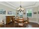 Charming dining room featuring a round table, chandelier, and decorative wall art at 7315 Bianco Duck Ct, Sarasota, FL 34240