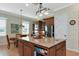 Spacious kitchen with a large granite island, stainless steel appliances, and pendant lighting at 7315 Bianco Duck Ct, Sarasota, FL 34240