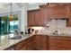 The kitchen features granite countertops, a stainless steel sink, and dark wood cabinetry at 7315 Bianco Duck Ct, Sarasota, FL 34240