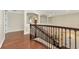 Open landing with hardwood floors, decorative railing, and views of the lower level at 7315 Bianco Duck Ct, Sarasota, FL 34240