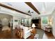 Bright living room with wood beams, a ceiling fan, and hardwood floors at 7315 Bianco Duck Ct, Sarasota, FL 34240