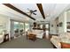 Spacious living room with access to outdoor pool area and views into the kitchen at 7315 Bianco Duck Ct, Sarasota, FL 34240