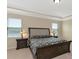 The main bedroom has a tray ceiling, carpeted floors, and large windows at 7315 Bianco Duck Ct, Sarasota, FL 34240