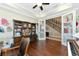 Comfortable home office space with hardwood floors, a ceiling fan, and plenty of built-in shelving at 7315 Bianco Duck Ct, Sarasota, FL 34240