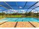 Enclosed pool area with brick patio, and a view of pond and manicured lawn at 7315 Bianco Duck Ct, Sarasota, FL 34240