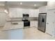 Modern kitchen featuring stainless steel appliances, granite countertops, and ample white cabinetry at 1857 Spaniel Ave, North Port, FL 34288
