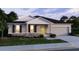 Charming single-story home with a stone facade, a two-car garage, and a well-manicured lawn at 11427 Pickford St, Spring Hill, FL 34609