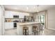 Modern kitchen with stainless steel appliances, granite countertops, and a center island with bar stool seating at 11427 Pickford St, Spring Hill, FL 34609