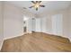Spacious bedroom with hardwood floors, ceiling fan, closet, and ensuite bathroom at 5857 Fishhawk Ridge Dr, Lithia, FL 33547