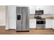 Well-equipped kitchen with stainless steel appliances and white cabinetry at 5857 Fishhawk Ridge Dr, Lithia, FL 33547