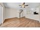 Open-concept living room and kitchen area with hardwood floors and ceiling fan at 5857 Fishhawk Ridge Dr, Lithia, FL 33547