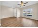 Living room with hardwood floors, a ceiling fan, and a large window at 5857 Fishhawk Ridge Dr, Lithia, FL 33547