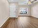 Cozy living room showcasing hardwood floors, neutral paint, and bright natural light at 5857 Fishhawk Ridge Dr, Lithia, FL 33547