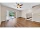 Bright living room featuring wood floors, ceiling fan, and sliding glass doors to the patio at 5857 Fishhawk Ridge Dr, Lithia, FL 33547