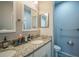 Well-lit bathroom featuring double sinks with granite countertops and modern fixtures at 3610 N Tampa St, Tampa, FL 33603