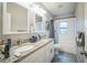 Bathroom featuring double sinks, granite countertops, modern fixtures, and a shower-tub combo at 3610 N Tampa St, Tampa, FL 33603