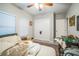 Bedroom with a ceiling fan, closed closet doors, and an unmade bed near a window at 3610 N Tampa St, Tampa, FL 33603
