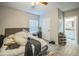 Bedroom leading to a bathroom, complete with an unmade bed, and a shoe rack at 3610 N Tampa St, Tampa, FL 33603