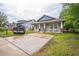 Inviting home featuring a spacious driveway and a well-maintained lawn; perfect for families at 3610 N Tampa St, Tampa, FL 33603