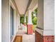 Relaxing front porch with seating and brick accents, creating a welcoming entrance to the home at 3610 N Tampa St, Tampa, FL 33603
