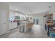 Modern kitchen island with granite countertop and seating, stainless appliances, and white cabinets, open to back yard at 3610 N Tampa St, Tampa, FL 33603