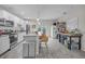 A bright kitchen with a granite countertop island with seating, stainless steel appliances and gray wood flooring at 3610 N Tampa St, Tampa, FL 33603