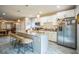 Modern kitchen island with granite countertop and seating, stainless appliances, and white cabinets at 3610 N Tampa St, Tampa, FL 33603
