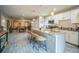 Modern kitchen island with granite countertop and seating, stainless appliances, and white cabinets at 3610 N Tampa St, Tampa, FL 33603