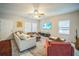 Bright living room with a large sofa, ceiling fan, and TV, perfect for relaxation and gatherings at 3610 N Tampa St, Tampa, FL 33603