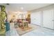 Open-concept living room featuring hardwood floors, an area rug, and ample space for both dining and entertaining at 3610 N Tampa St, Tampa, FL 33603