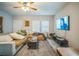 Cozy living room with a ceiling fan, large sectional sofa, and mounted TV for entertainment at 3610 N Tampa St, Tampa, FL 33603