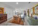 Open-concept living room featuring hardwood floors, an area rug, and ample space for both dining and entertaining at 3610 N Tampa St, Tampa, FL 33603