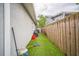 Side yard with artificial grass and wood fence at 3610 N Tampa St, Tampa, FL 33603