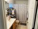Well-lit bathroom with shower/tub combo, vanity, and shelving at 4147 Kingsfield Dr, Parrish, FL 34219