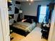 Bedroom with a full bed and geometric accent wall at 4147 Kingsfield Dr, Parrish, FL 34219
