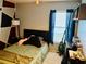 Bedroom with a full bed, geometric wall art, and a guitar at 4147 Kingsfield Dr, Parrish, FL 34219
