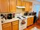 Kitchen with light wood cabinets, white appliances, and ample counter space at 4147 Kingsfield Dr, Parrish, FL 34219