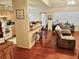 Open living room and kitchen with hardwood floors and breakfast bar at 4147 Kingsfield Dr, Parrish, FL 34219