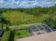 Screened lanai overlooks a large private backyard with a wooded view at 8749 Ashworth Dr, Tampa, FL 33647
