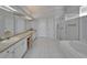 Bright bathroom with double sinks, vanity area, stand up shower and large tub at 8749 Ashworth Dr, Tampa, FL 33647