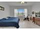 Bright bedroom with large window overlooking the yard, neutral paint, and wood floors at 8749 Ashworth Dr, Tampa, FL 33647