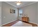 Bedroom with dark flooring, dresser, picture and natural lighting at 8749 Ashworth Dr, Tampa, FL 33647