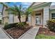 Home featuring a beautifully landscaped front entrance, charming walkway, and a stylish front door at 8749 Ashworth Dr, Tampa, FL 33647