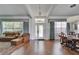 Bright living room featuring hardwood floors, coffered ceilings, large windows and elegant furniture at 8749 Ashworth Dr, Tampa, FL 33647