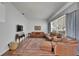 Spacious living room with hardwood floors, a large window, comfortable furniture, and a stylish rug at 8749 Ashworth Dr, Tampa, FL 33647